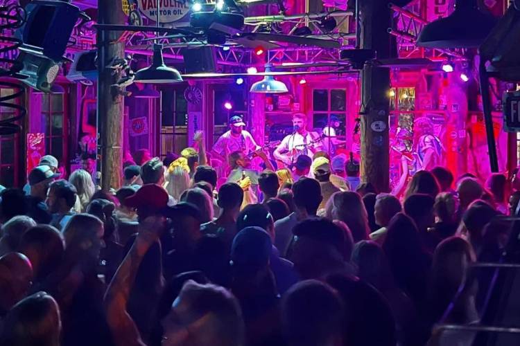 Band performing music for a crowd at AJ's Grayton Band performing music for a crowd at AJ's Grayton